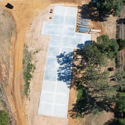 aerial view of concrete slab foundation for 50x235 metal building near Columbus Texas